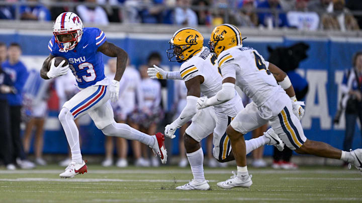 Cal safeties Craig Woodson and Miles Williams chase SMU wide receiver Roderick Daniels Jr. 