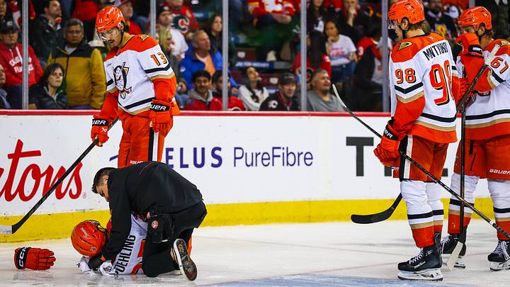 Oct 10, 2026; Calgary, Alberta, CAN; Anaheim Ducks center Ryan Poehling (25) gets help of the ice after his collision with the net of the Calgary Flames goaltender Dustin Wolf (32) during the third period at Scotiabank Saddledome. Mandatory Credit: Sergei Belski-Imagn Images Oct 10, 2026; Calgary, Alberta, CAN; Anaheim Ducks center Ryan Poehling (25) gets help of the ice after his collision with the net of the Calgary Flames goaltender Dustin Wolf (32) during the third period at Scotiabank Saddledome. Mandatory Credit: Sergei Belski-Imagn Images
