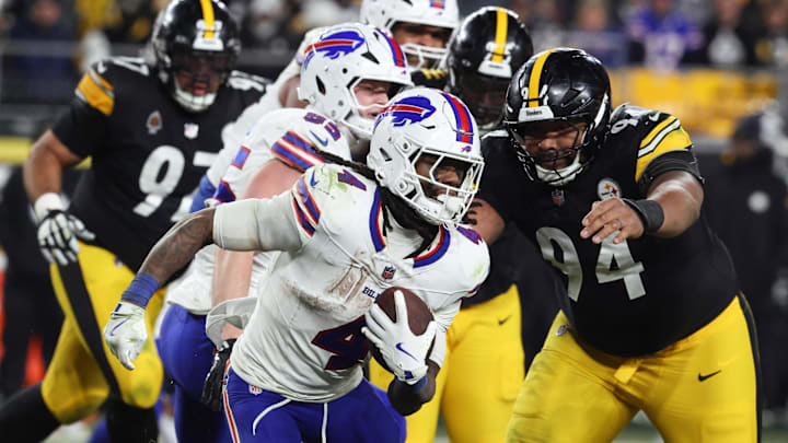 Nov 30, 2025; Pittsburgh, Pennsylvania, USA;  Buffalo Bills running back James Cook III (4) rushes as Pittsburgh Steelers defensive end Yahya Black (94) defends during the fourth quarter at Acrisure Stadium