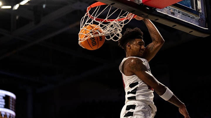 Cincinnati Bearcats forward Dillon Mitchell (23) dunks in the first half of the NCAA basketball game against the Alabama State Hornets at Fifth Third Arena in Cincinnati on Wednesday, Nov. 27, 2024. Cincinnati Bearcats forward Dillon Mitchell (23) dunks in the first half of the NCAA basketball game against the Alabama State Hornets at Fifth Third Arena in Cincinnati on Wednesday, Nov. 27, 2024.