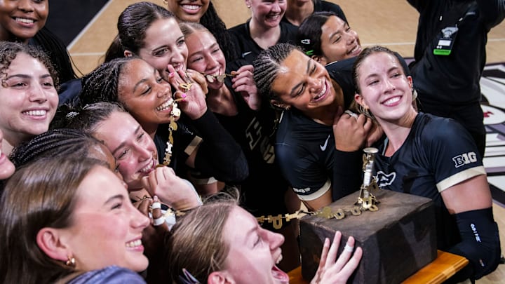 The Purdue Boilermakers pose with the trophy after winning the Monon Spike Match