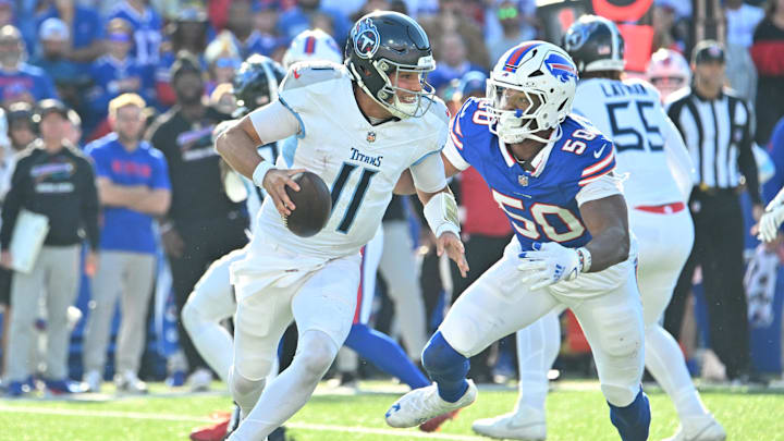 Oct 20, 2024; Orchard Park, New York, USA; Tennessee Titans quarterback Mason Rudolph (11) is pressured by Buffalo Bills defensive end Greg Rousseau (50) in the fourth quarter at Highmark Stadium. Mandatory Credit: Mark Konezny-Imagn Images