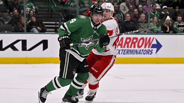 Jan 19, 2025; Dallas, Texas, USA; Dallas Stars defenseman Miro Heiskanen (4) and Detroit Red Wings right wing Jonatan Berggren (48) chase the puck during the third period at the American Airlines Center. Mandatory Credit: Jerome Miron-Imagn Images