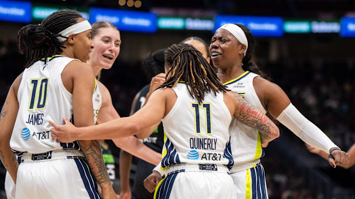 Jul 22, 2025; Seattle, Washington, USA;  Dallas Wings, from left, guard Aziaha James (10), center Luisa Geiselsoder (18) guard JJ Quinerly (11) and guard Arike Ogunbowale (24) celebrate during the second half against the Seattle Storm at Climate Pledge Arena. Mandatory Credit: Stephen Brashear-Imagn Images