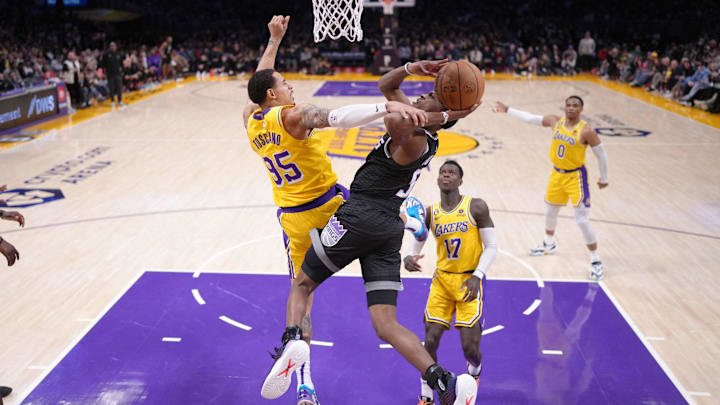 Jan 18, 2023; Los Angeles, California, USA; Sacramento Kings guard De'Aaron Fox (5) shoots the ball against Los Angeles Lakers forward Juan Toscano-Anderson (95) in the second half at Crypto.com Arena. Mandatory Credit: Kirby Lee-Imagn Images