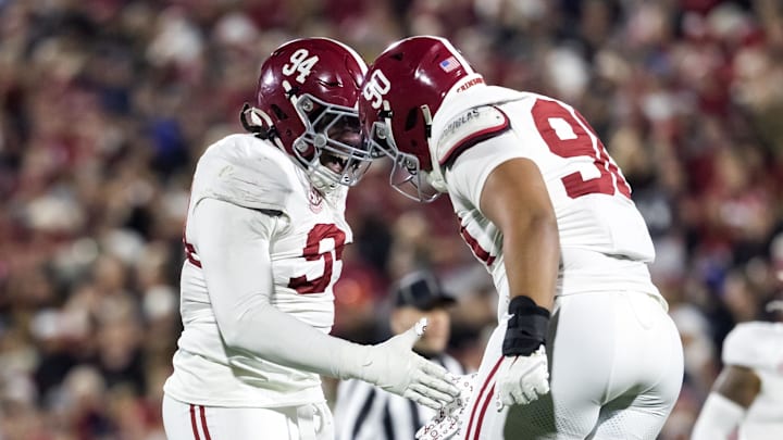 Dec 19, 2025; Norman, OK, USA; Alabama Crimson Tide defensive lineman Edric Hill (94) and London Simmons (90) celebrate a play against the Oklahoma Sooners during the CFP National Playoff First Round at Gaylord Family Oklahoma Memorial Stadium. Mandatory Credit: Mark J. Rebilas-Imagn Images