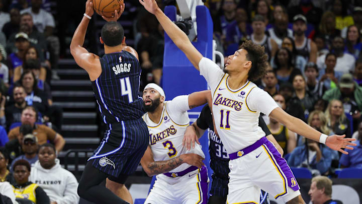 Nov 4, 2023; Orlando, Florida, USA; Orlando Magic guard Jalen Suggs (4) shoots the ball against Los Angeles Lakers forward Anthony Davis (3) and center Jaxson Hayes (11) during the first quarter at Amway Center. Mandatory Credit: Mike Watters-Imagn Images