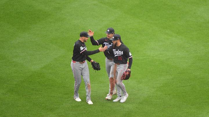 May 24, 2026; Boston, Massachusetts, USA;  Minnesota Twins left fielder Trevor Larnach (9) center fielder James Outman (30) and right fielder Austin Martin (16) celebrate after defeating the Boston Red Sox at Fenway Park. Mandatory Credit: Bob DeChiara-Imagn Images
