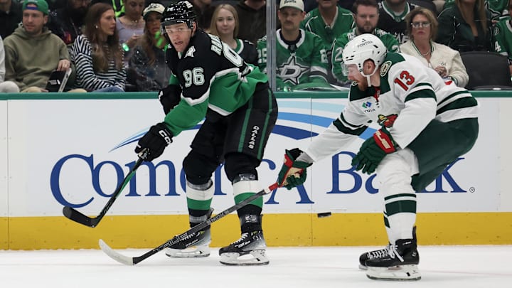Apr 18, 2026; Dallas, Texas, USA; Dallas Stars right wing Mikko Rantanen (96) saucers passes the puck against Minnesota Wild center Yakov Trenin (13) in the first period in game one of the first round of the 2026 Stanley Cup Playoffs at American Airlines Center. Mandatory Credit: Thomas Shea-Imagn Images