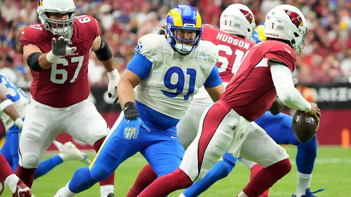 Sep 25, 2022; Glendale, Ariz., U.S.;  Arizona Cardinals quarterback Kyler Murray (1) is flushed out of the pocket by Los Angeles Rams defensive tackle Greg Gaines (91) during the first quarter at State Farm Stadium.