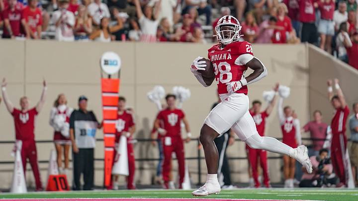 Sep 12, 2025; Bloomington, Indiana, USA; Indiana Hoosiers running back Khobie Martin (28) runs for a touchdown during the second half against the Indiana State Sycamores at Memorial Stadium. Mandatory Credit: Robert Goddin-Imagn Images
