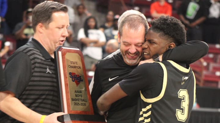 North Augusta head coach Tim Harrell is hugged by guard Zay Harris. North Augusta head coach Tim Harrell is hugged by guard Zay Harris.