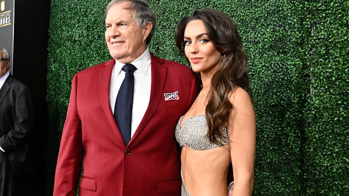 Bill Belichick and Jordon Hudson pose on the red carpet before the Super Bowl LIX NFL Honors ceremony. 