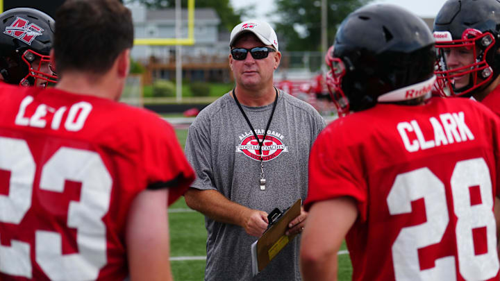 Head coach Ken Krause works with players during football practice at Muskego High School on Thursday, August 8, 2024.
