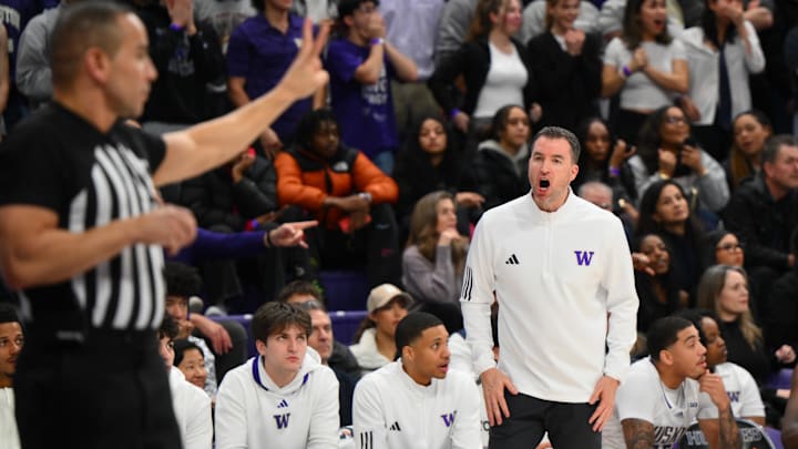 Jan 15, 2025; Seattle, Washington, USA; Washington Huskies head coach Danny Sprinkle interacts with the referee during the first half against the Purdue Boilermakers at Alaska Airlines Arena at Hec Edmundson Pavilion. Mandatory Credit: Steven Bisig-Imagn Images