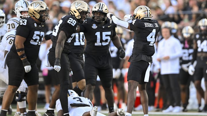Aug 30, 2025; Nashville, Tennessee, USA;  Vanderbilt Commodores cornerback Martel Hight (4) celebrates his tackle for loss against the Charleston Southern Buccaneers during the first half at FirstBank Stadium. Mandatory Credit: Steve Roberts-Imagn Images