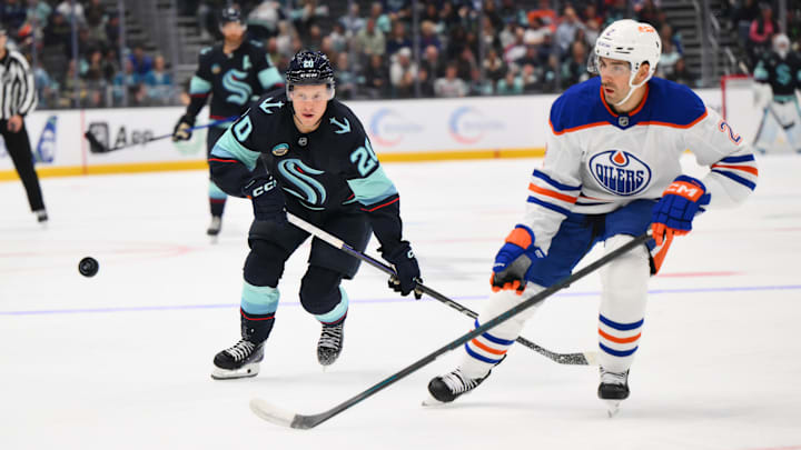 Seattle Kraken right wing Eeli Tolvanen (20) and Edmonton Oilers defenseman Evan Bouchard (2)