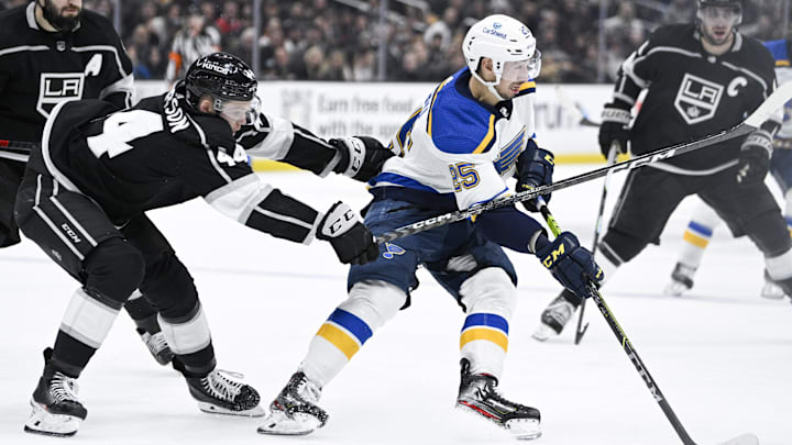Mar 4, 2023; Los Angeles, California, USA;St. Louis Blues center Jordan Kyrou (25) moves the puck while pressured by Los Angeles Kings defenseman Mikey Anderson (44) during the third period at Crypto.com Arena. The Kings won 3-2. Mandatory Credit: Kelvin Kuo-Imagn Images