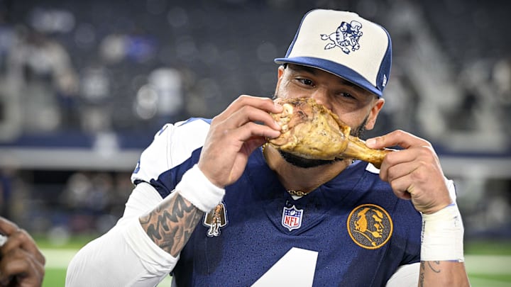 Dallas Cowboys Dak Prescott eats a turkey leg after the Cowboys' victory over the Washington Commanders.