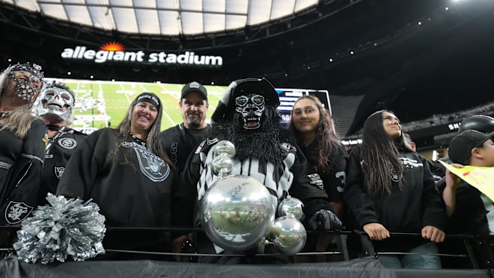 Dec 28, 2025; Paradise, Nevada, USA; Las Vegas Raiders fans (From left: Marilyn Acasio aka Jungle Jane, Geoff Skarr, Mark Acasio aka Gorilla Rilla and Alyssa Skarr cheer in the second half against the New York Giants at Allegiant Stadium. Mandatory Credit: Kirby Lee-Imagn Images