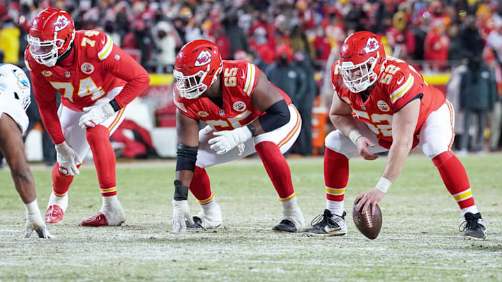Jan 13, 2024; Kansas City, Missouri, USA; Kansas City Chiefs offensive tackle Jawaan Taylor (74) and guard Trey Smith (65) and center Creed Humphrey (52) at the line of scrimmage against the Miami Dolphins in a 2024 AFC wild card game at GEHA Field at Arrowhead Stadium. Mandatory Credit: Denny Medley-Imagn Images