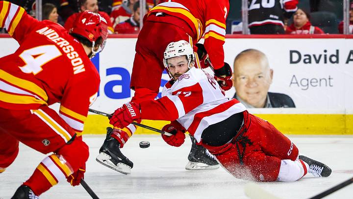 Dec 10, 2025; Calgary, Alberta, CAN; Detroit Red Wings center Michael Rasmussen (27) shoots the puck against the Calgary Flames during the third period at Scotiabank Saddledome. Mandatory Credit: Sergei Belski-Imagn Images