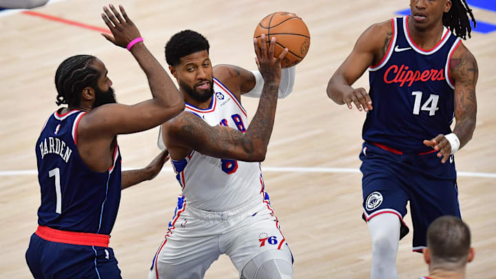 Nov 6, 2024; Inglewood, California, USA; Philadelphia 76ers forward Paul George (8) moves to the basket against Los Angeles Clippers guard James Harden (1) and guard Terance Mann (14) during the second half at Intuit Dome. Mandatory Credit: Gary A. Vasquez-Imagn Images