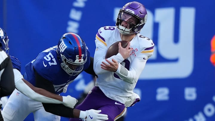 Dec 21, 2025; East Rutherford, New Jersey, USA; New York Giants defensive end Chauncey Golston (57) sacks Minnesota Vikings quarterback J.J. McCarthy (9) during the first half at MetLife Stadium. Mandatory Credit: Robert Deutsch-Imagn Images