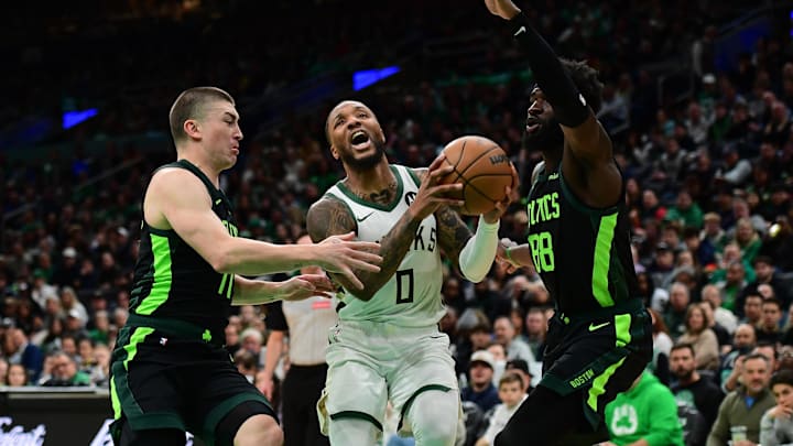 Dec 6, 2024; Boston, Massachusetts, USA; Milwaukee Bucks guard Damian Lillard (0) drives to the basket between Boston Celtics guard Payton Pritchard (11) and center Neemias Queta (88) during the first half at TD Garden. Mandatory Credit: Bob DeChiara-Imagn Images Dec 6, 2024; Boston, Massachusetts, USA; Milwaukee Bucks guard Damian Lillard (0) drives to the basket between Boston Celtics guard Payton Pritchard (11) and center Neemias Queta (88) during the first half at TD Garden. Mandatory Credit: Bob DeChiara-Imagn Images