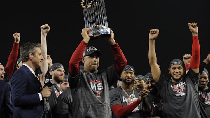 Boston Red Sox manager Alex Cora hoists the Commissioner's Trophy after defeating the Los Angeles Dodgers in game five of the 2018 World Series at Dodger Stadium.