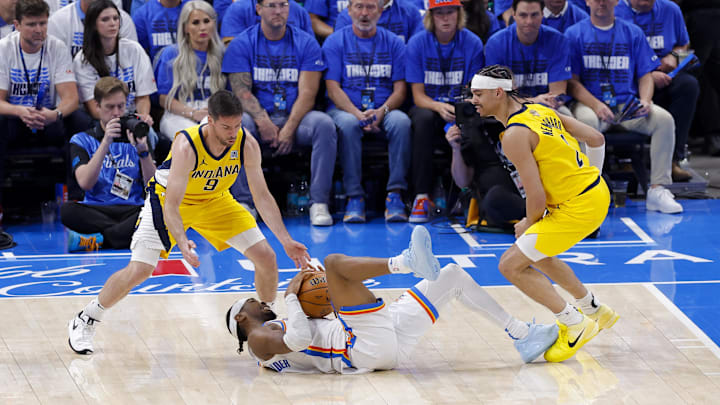 Jun 16, 2025; Oklahoma City, Oklahoma, USA; Oklahoma City Thunder guard Shai Gilgeous-Alexander (2) grabs a loose ball as Indiana Pacers guard T.J. McConnell (9) and guard Andrew Nembhard (2) look on during the third quarter in game five of the 2025 NBA Finals at Paycom Center. Mandatory Credit: Alonzo Adams-Imagn Images Jun 16, 2025; Oklahoma City, Oklahoma, USA; Oklahoma City Thunder guard Shai Gilgeous-Alexander (2) grabs a loose ball as Indiana Pacers guard T.J. McConnell (9) and guard Andrew Nembhard (2) look on during the third quarter in game five of the 2025 NBA Finals at Paycom Center. Mandatory Credit: Alonzo Adams-Imagn Images