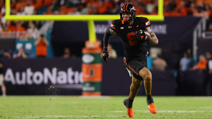 Oct 26, 2024; Miami Gardens, Florida, USA; Miami Hurricanes tight end Elijah Arroyo (8) runs with the football against the Florida State Seminoles during the third quarter at Hard Rock Stadium. Mandatory Credit: Sam Navarro-Imagn Images Oct 26, 2024; Miami Gardens, Florida, USA; Miami Hurricanes tight end Elijah Arroyo (8) runs with the football against the Florida State Seminoles during the third quarter at Hard Rock Stadium. Mandatory Credit: Sam Navarro-Imagn Images