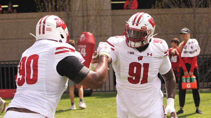 Wisconsin defensive lineman Jamel Howard (91) works with James Thompson before the team's intrasquad scrimmage on the field north of Camp Randall Stadium in Madison, Wisconsin on Saturday April 27, 2024.