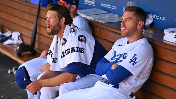 Jul 27, 2022; Los Angeles, California, USA; Los Angeles Dodgers third baseman Max Muncy (13) and pitcher Clayton Kershaw (22) and first baseman Freddie Freeman (5) look on from the dugout during the sixth inning against the Washington Nationals at Dodger Stadium. Mandatory Credit: Jayne Kamin-Oncea-Imagn Images
