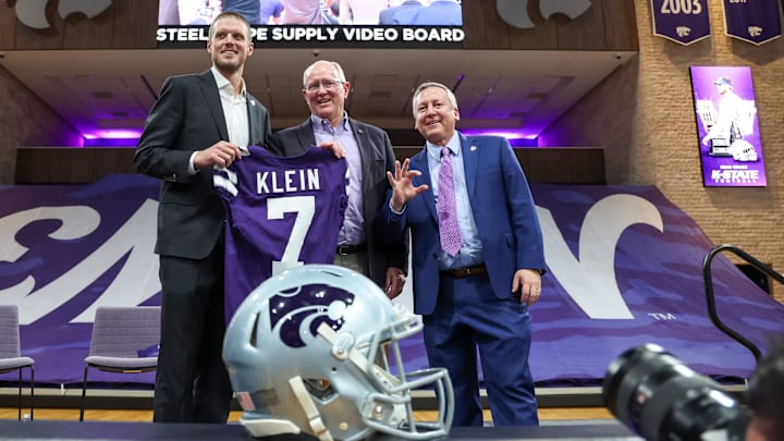 Collin Klein, athletic director Gene Taylor and K-State President Richard Litton hold a jersey after Klein was named the new head coach of the Kansas State Wildcats football team at Morgan Family Arena. Collin Klein, athletic director Gene Taylor and K-State President Richard Litton hold a jersey after Klein was named the new head coach of the Kansas State Wildcats football team at Morgan Family Arena.