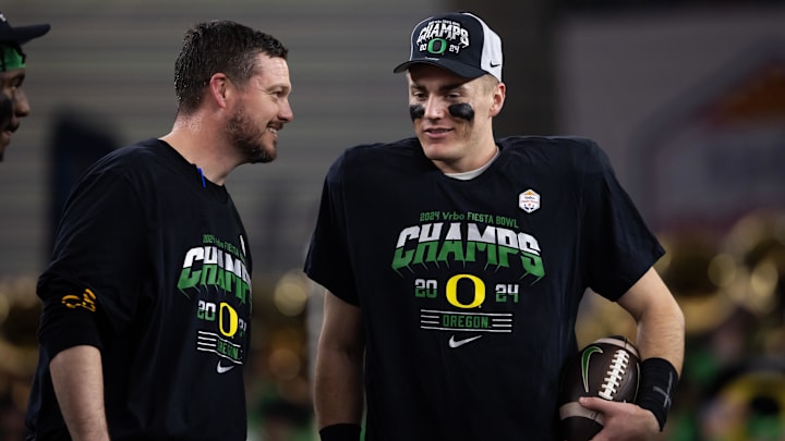Jan 1, 2024; Glendale, AZ, USA; Oregon Ducks quarterback Bo Nix (right) celebrates with head coach Dan Lanning after defeating the Liberty Flames during the 2024 Fiesta Bowl at State Farm Stadium. Mandatory Credit: Mark J. Rebilas-USA TODAY Sports