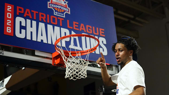 Mar 11, 2026; Bethlehem, Pennsylvania, USA; Lehigh Mountain Hawks guard Nasir Whitlock (1) cuts down the net after defeating the Boston University Terriers in the Patriot League Championship at Stabler Arena. Mandatory Credit: James Lang-Imagn Images
