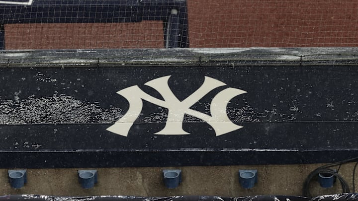 Aug 17, 2020; Bronx, New York, USA; A general view of rain falling on the  New York Yankees logo on the first base dugout roof during a rain delay in the game between the New York Yankees and the Boston Red Sox. Mandatory Credit: Vincent Carchietta-Imagn Images