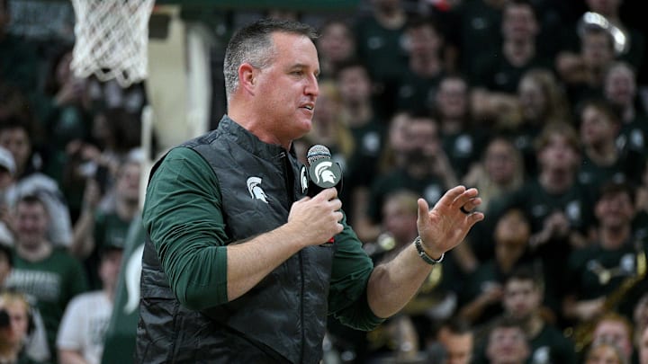 Dec 2, 2025; East Lansing, Michigan, USA; Michigan State head football coach Pat Fitzgerald watches the Spartans defeat the Iowa Hawkeyes at Jack Breslin Student Events Center. Mandatory Credit: Dale Young-Imagn Images Dec 2, 2025; East Lansing, Michigan, USA; Michigan State head football coach Pat Fitzgerald watches the Spartans defeat the Iowa Hawkeyes at Jack Breslin Student Events Center. Mandatory Credit: Dale Young-Imagn Images