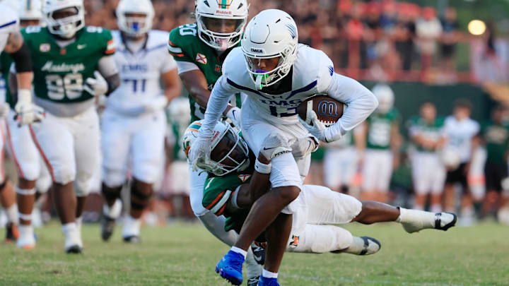 IMG Academy's Osani Gayles rushes for yards against Mandarin's Tamajh Mitchell IMG Academy's Osani Gayles rushes for yards against Mandarin's Tamajh Mitchell