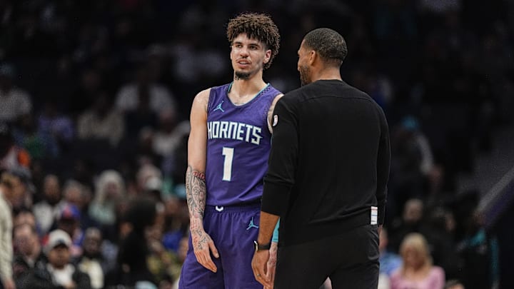 Mar 20, 2025; Charlotte, North Carolina, USA; Charlotte Hornets guard LaMelo Ball (1) talks with head coach Charles Lee  during a  free throw during the second half against the New York Knicks at Spectrum Center. Mandatory Credit: Jim Dedmon-Imagn Images