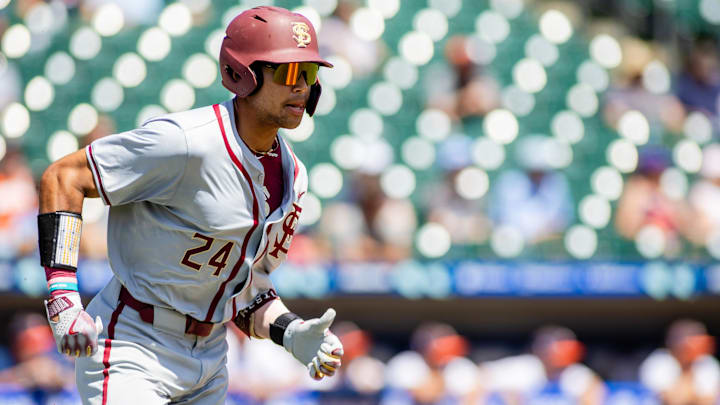 May 24, 2024; Charlotte, NC, USA; Florida State Seminoles infielder Cam Smith (24) runs to first on a double against the Virginia Cavaliers in the fourth inning during the ACC Baseball Tournament at Truist Field.