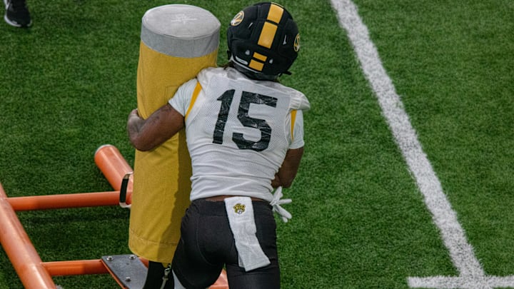 Aug 18, 2025; Columbia, MO, USA; Missouri Tigers safety Santana Banner (15) tackles a dummy at a fall camp practice at Stephens Indoor Facility. 
