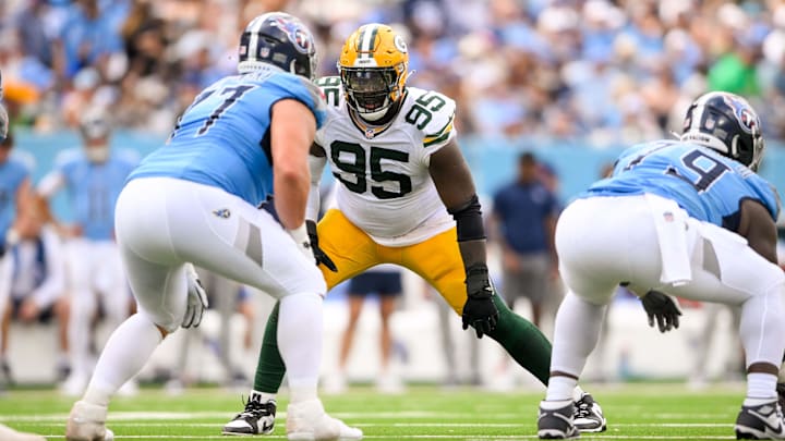 Sep 22, 2024; Nashville, Tennessee, USA;  Green Bay Packers defensive tackle Devonte Wyatt (95) goes against Tennessee Titans offensive tackle Peter Skoronski (77) during the first half at Nissan Stadium. Mandatory Credit: Steve Roberts-Imagn Images