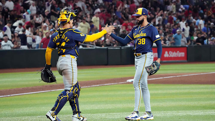 Sep 13, 2024; Phoenix, Arizona, USA; Milwaukee Brewers catcher William Contreras (24) and Milwaukee Brewers pitcher Devin Williams (38) slap hands after defeating the Arizona Diamondbacks at Chase Field. Mandatory Credit: Joe Camporeale-Imagn Images