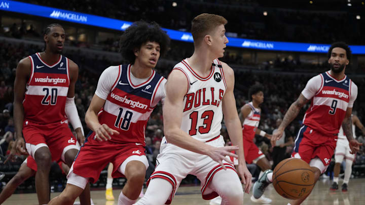 Apr 11, 2025; Chicago, Illinois, USA; Washington Wizards forward Kyshawn George (18) defends Chicago Bulls guard Kevin Huerter (13) during the first quarter at United Center. Mandatory Credit: David Banks-Imagn Images