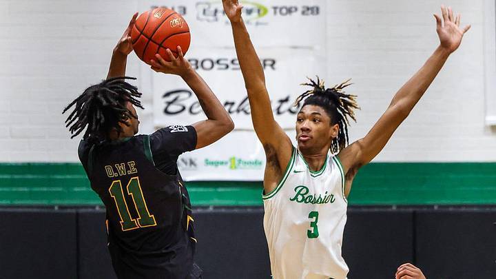 Bossier forward Kerel Woods (3) defending a 3-point shot by Calvary guard Tyrone Jamison (11) at the Bossier Basketball Invitational on Saturday, January 6, 2024, in Bossier City, La.
