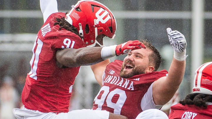 Indiana's James Carpenter (99) celebrates with Daniel Ndukwe (91) after Ndukwe blocked a punt against Maryland at Memorial Stadium.