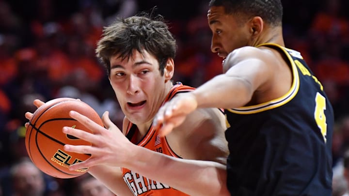 Feb 27, 2026; Champaign, Illinois, USA; Illinois Fighting Illini forward David Mirkovic (0) drives the ball against Michigan Wolverines guard Nimari Burnett (4) during the first half at State Farm Center. Mandatory Credit: Ron Johnson-Imagn Images Feb 27, 2026; Champaign, Illinois, USA; Illinois Fighting Illini forward David Mirkovic (0) drives the ball against Michigan Wolverines guard Nimari Burnett (4) during the first half at State Farm Center. Mandatory Credit: Ron Johnson-Imagn Images
