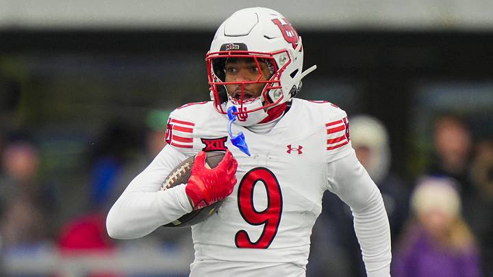 Nov 28, 2025; Lawrence, Kansas, USA; Utah Utes cornerback Elijah Davis (9) returns an interception for a touchdown during the second half against the Kansas Jayhawks at David Booth Kansas Memorial Stadium. Mandatory Credit: Jay Biggerstaff-Imagn Images